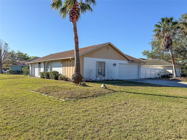 single story home featuring driveway, an attached garage, and a front lawn