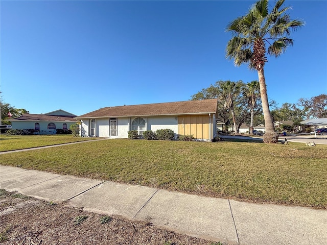 ranch-style home featuring a front lawn and an attached garage