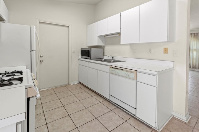 kitchen featuring light countertops, light tile patterned floors, white appliances, white cabinetry, and a sink