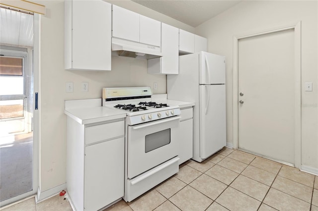 kitchen featuring under cabinet range hood, light tile patterned floors, white appliances, and light countertops