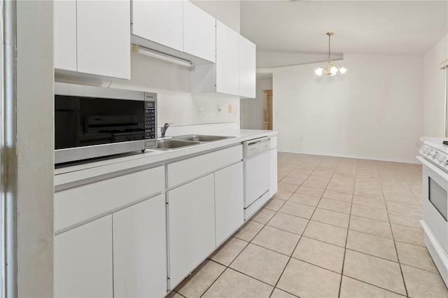 kitchen with light countertops, an inviting chandelier, white cabinets, white appliances, and a sink