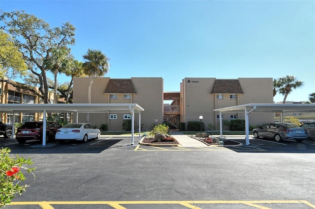 view of building exterior featuring covered parking