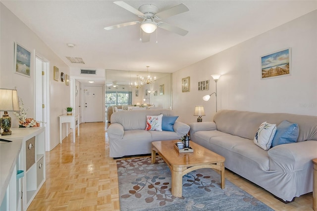 living area with visible vents and ceiling fan with notable chandelier