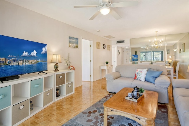 living room with ceiling fan with notable chandelier and visible vents