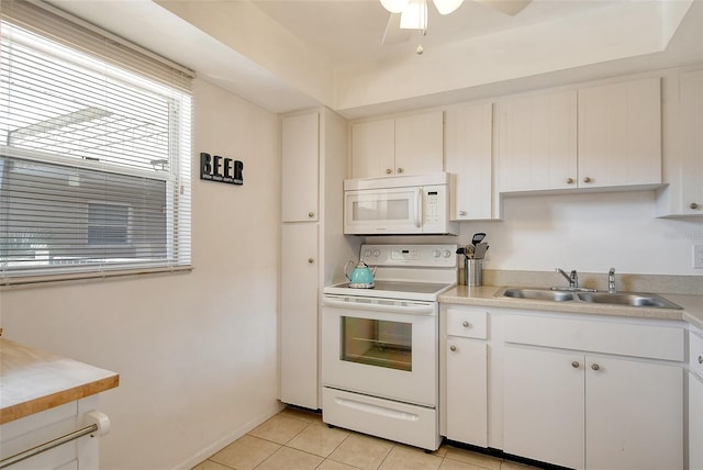 kitchen featuring a sink, white appliances, light tile patterned flooring, light countertops, and ceiling fan