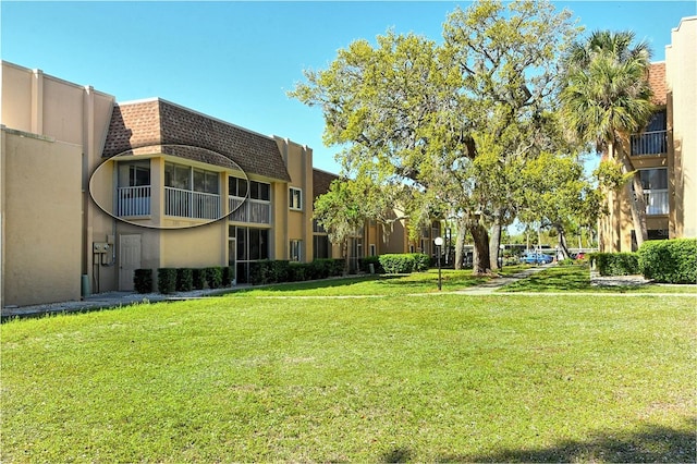 view of property's community with a lawn