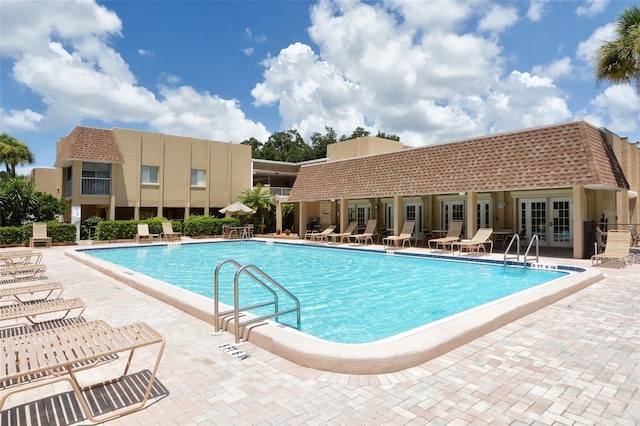 community pool featuring french doors and a patio