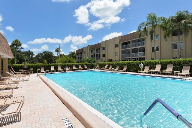 community pool featuring a patio and fence