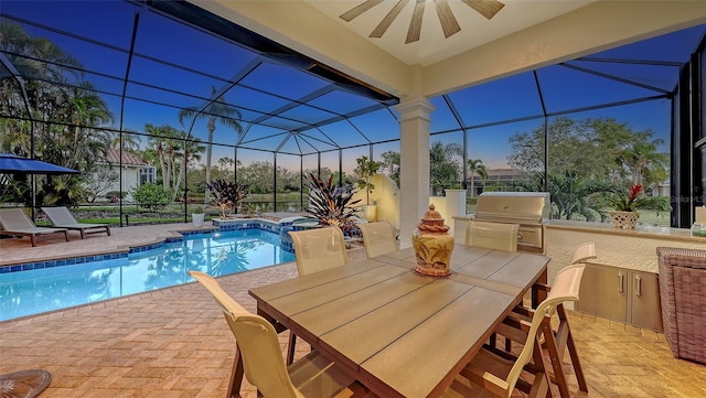 outdoor pool featuring a lanai, a patio, an outdoor kitchen, and a ceiling fan