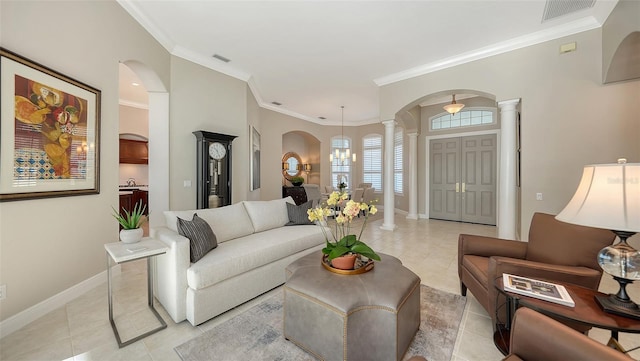 living room featuring visible vents, baseboards, arched walkways, light tile patterned flooring, and ornate columns