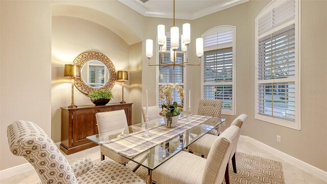 dining room featuring baseboards, a chandelier, light tile patterned flooring, and ornamental molding