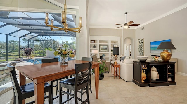 dining area featuring arched walkways, crown molding, ceiling fan, and light tile patterned flooring