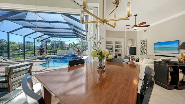 dining room with built in shelves, ceiling fan, ornamental molding, light tile patterned floors, and a sunroom