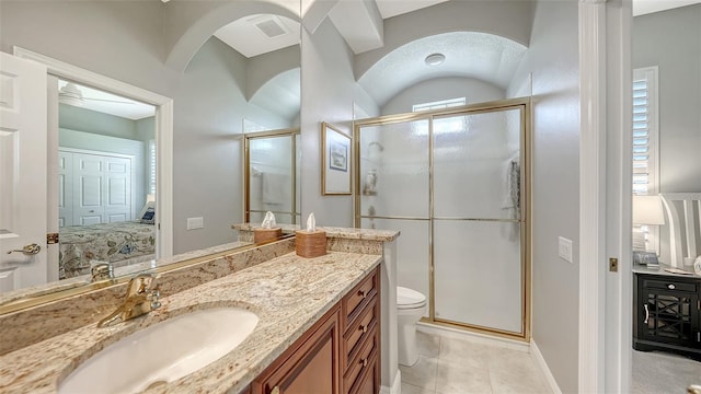 ensuite bathroom with visible vents, toilet, vanity, a stall shower, and ensuite bath