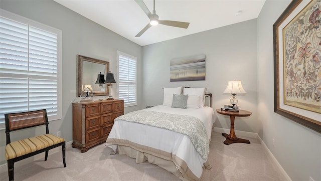 bedroom with baseboards, light colored carpet, and ceiling fan