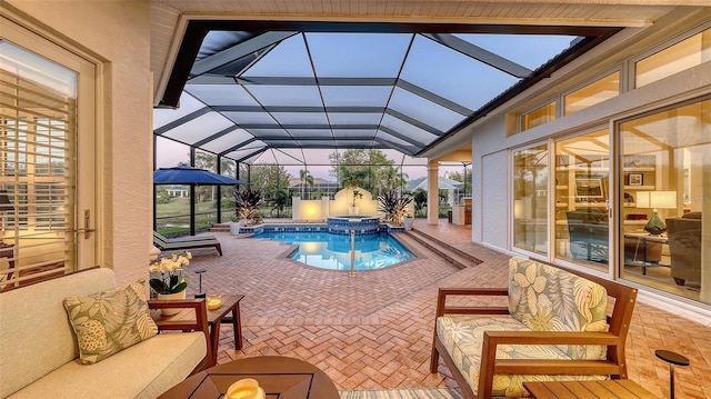 view of pool featuring a patio area, an outdoor hangout area, a pool with connected hot tub, and a lanai