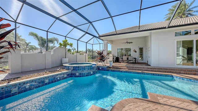 view of pool with a lanai, a pool with connected hot tub, ceiling fan, and a patio area