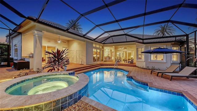 view of swimming pool featuring a lanai, a patio, ceiling fan, and a pool with connected hot tub