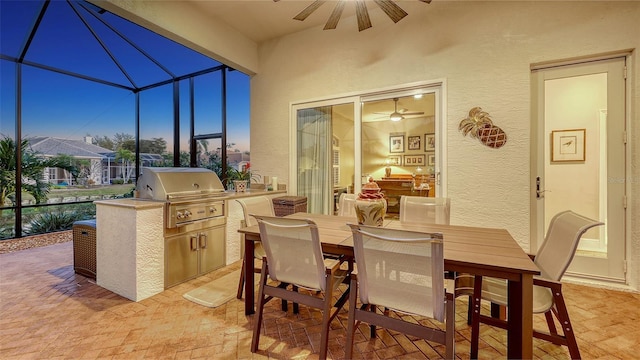 view of patio / terrace with outdoor dining space, a ceiling fan, exterior kitchen, area for grilling, and a lanai