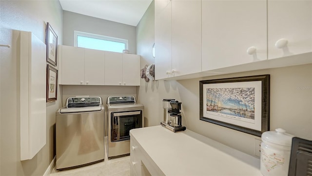 washroom with light tile patterned floors, cabinet space, and separate washer and dryer