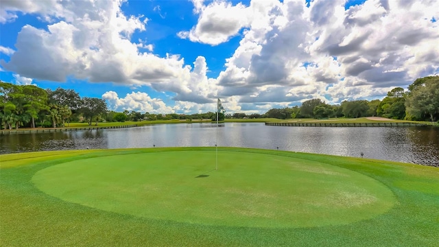 view of home's community with a water view and golf course view