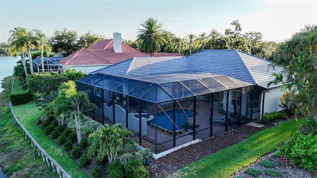 7340 Barclay Ct, University Park, FL 34201 - back of property with a patio, an outdoor pool, glass enclosure, a jacuzzi, and stucco siding