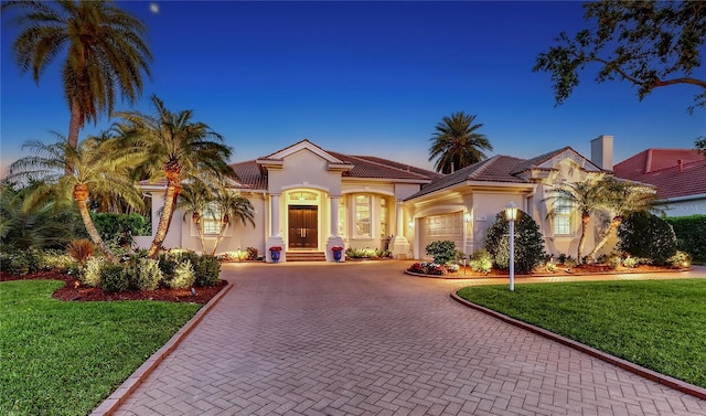 7340 Barclay Ct, University Park, FL 34201 - mediterranean / spanish-style house with decorative driveway, a garage, stucco siding, a front yard, and a tiled roof