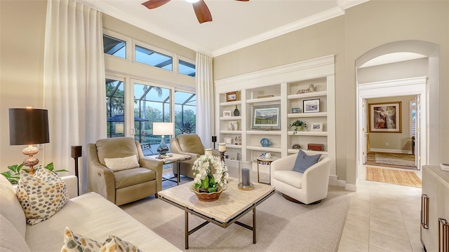 7340 Barclay Ct, University Park, FL 34201 - living room featuring a ceiling fan, light tile patterned floors, ornamental molding, built in features, and arched walkways
