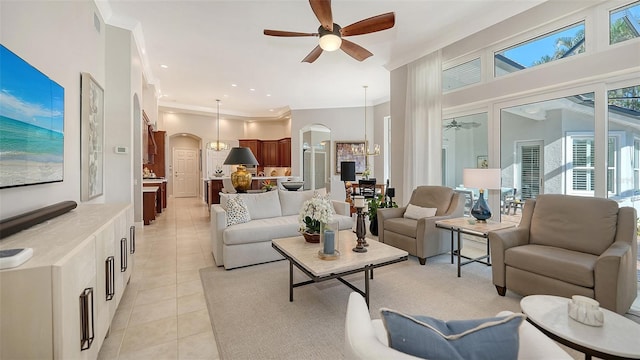 7340 Barclay Ct, University Park, FL 34201 - living area with arched walkways, ceiling fan, ornamental molding, light tile patterned flooring, and a chandelier