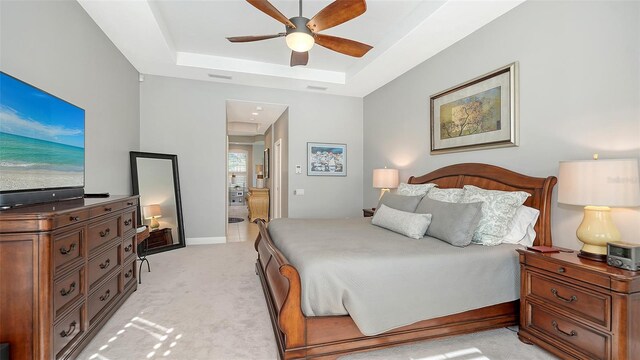 7340 Barclay Ct, University Park, FL 34201 - bedroom featuring a raised ceiling, attic access, light colored carpet, connected bathroom, and a ceiling fan