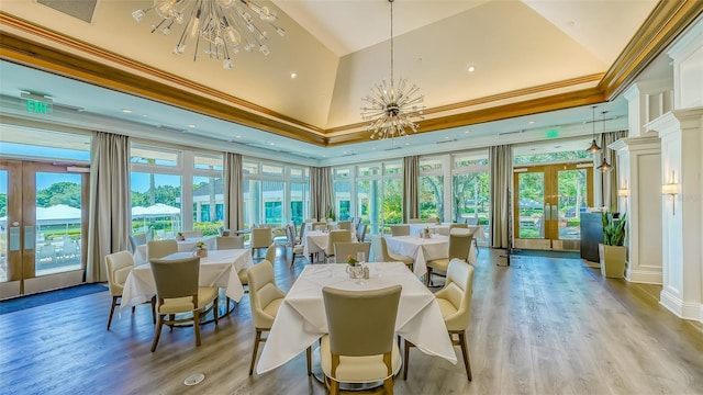 7340 Barclay Ct, University Park, FL 34201 - dining room with french doors, a chandelier, a towering ceiling, ornamental molding, and light wood-style floors
