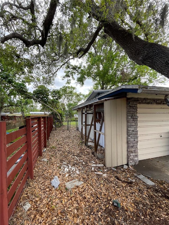 exterior space with an outbuilding and fence