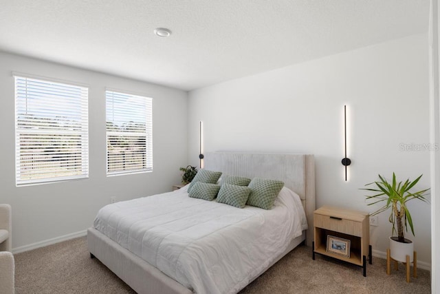 carpeted bedroom featuring baseboards