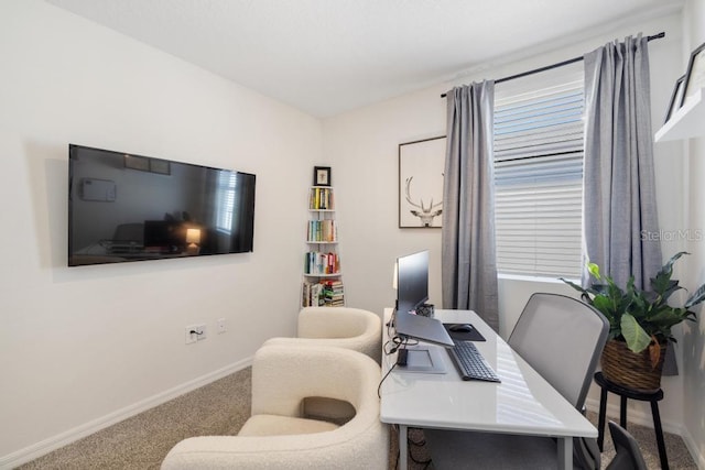 carpeted office space featuring baseboards