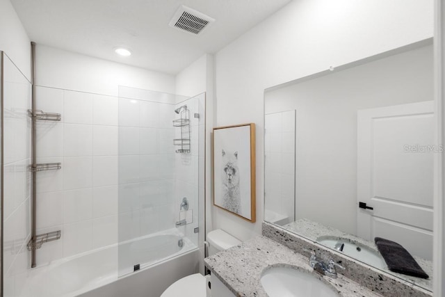 bathroom with visible vents, toilet, vanity, and washtub / shower combination