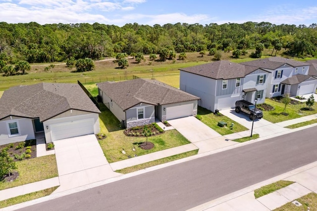 bird's eye view featuring a forest view and a residential view