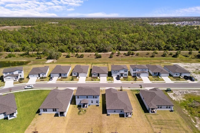 drone / aerial view with a residential view and a forest view