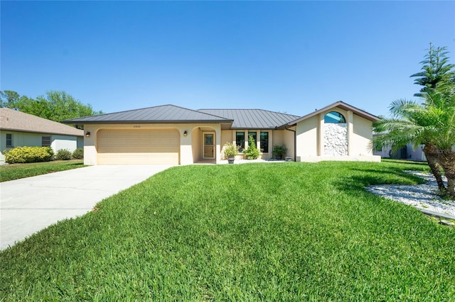 ranch-style home featuring a standing seam roof, metal roof, a garage, and stucco siding