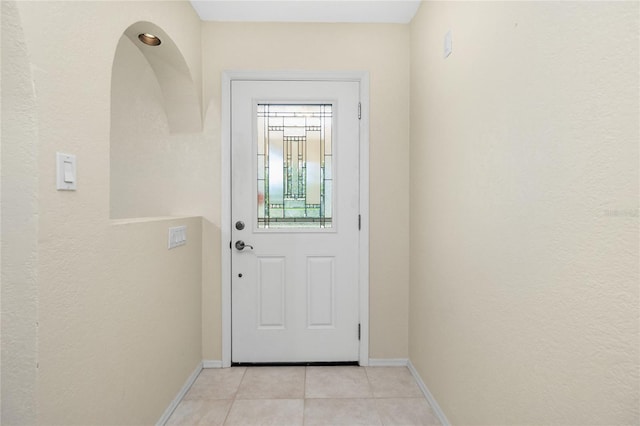 entryway featuring light tile patterned floors and baseboards