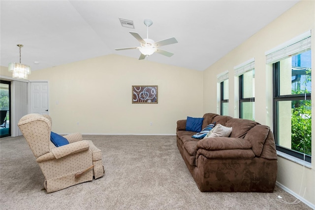 carpeted living area with visible vents, lofted ceiling, baseboards, and ceiling fan with notable chandelier