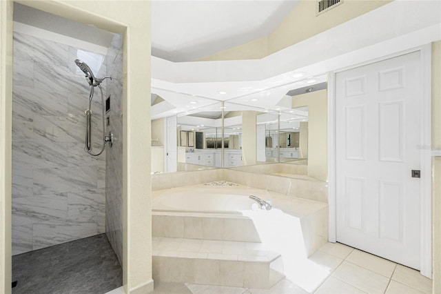 bathroom featuring visible vents, tiled shower, tile patterned flooring, vaulted ceiling, and a garden tub