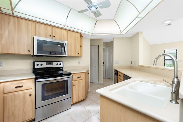 kitchen featuring light brown cabinets, visible vents, light tile patterned flooring, a sink, and stainless steel appliances