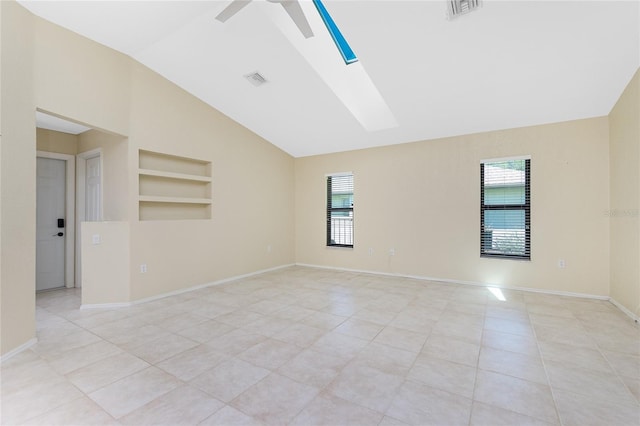 empty room featuring visible vents, baseboards, built in features, a skylight, and light tile patterned flooring