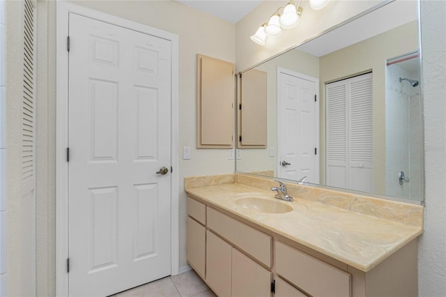 bathroom featuring vanity, tile patterned floors, and a closet