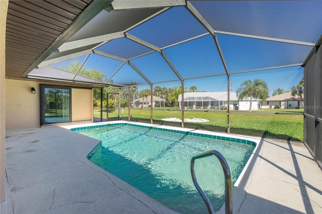 outdoor pool featuring a yard, glass enclosure, and a patio