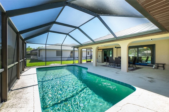 outdoor pool with a lanai and a patio