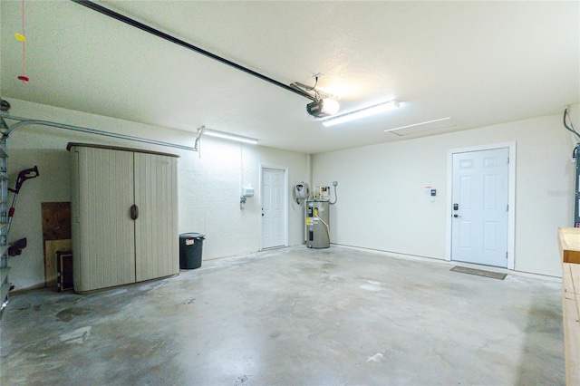 garage featuring a garage door opener and electric water heater