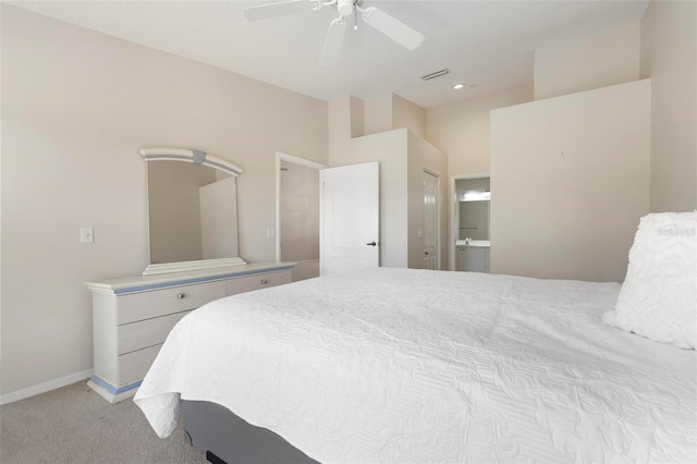 bedroom featuring visible vents, baseboards, light colored carpet, ensuite bathroom, and a ceiling fan