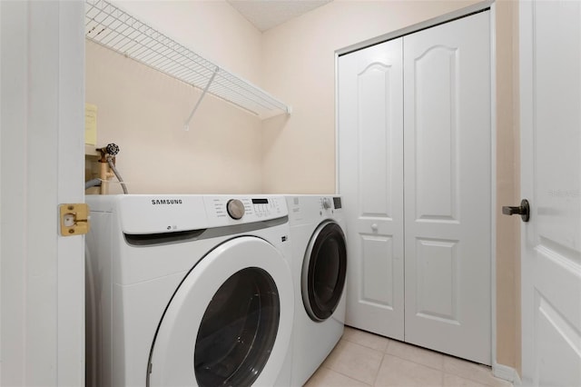 laundry area with light tile patterned floors, laundry area, and separate washer and dryer