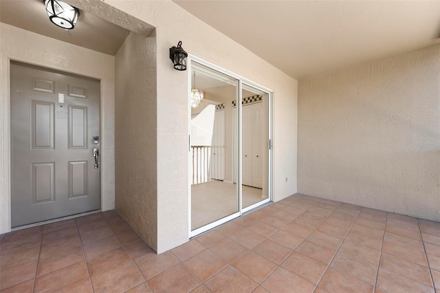 view of exterior entry with stucco siding